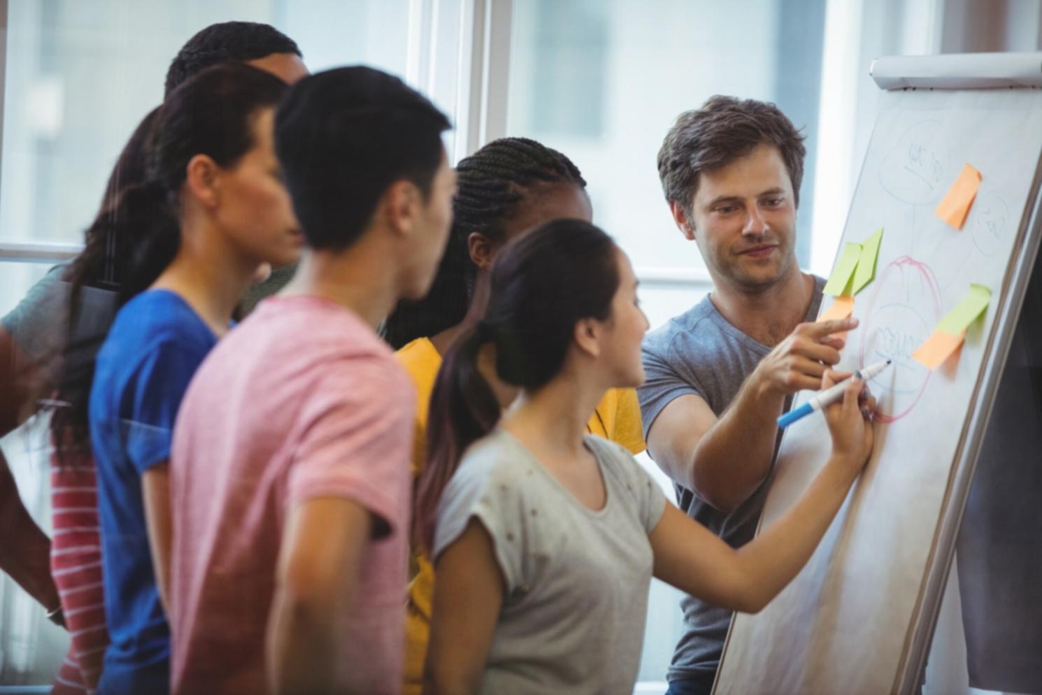 Students working through real budgeting exercises with calculators and worksheets